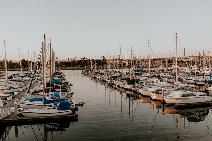 Marina view from our corporate party venue with sailboats and yachts anchored at sunset.