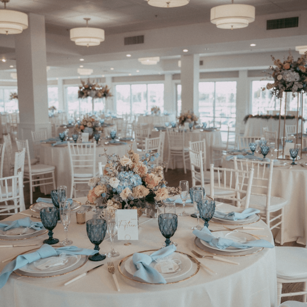 Wedding reception tables with floral centerpieces and fine details at Harbor View Loft