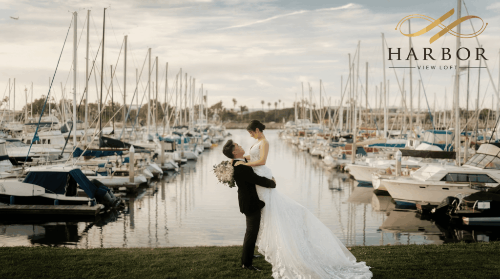 Bride and groom portrait by the marina with sailboats at Harbor View Loft