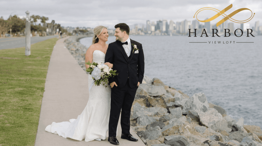 Couple portrait by the water with San Diego skyline at Harbor View Loft